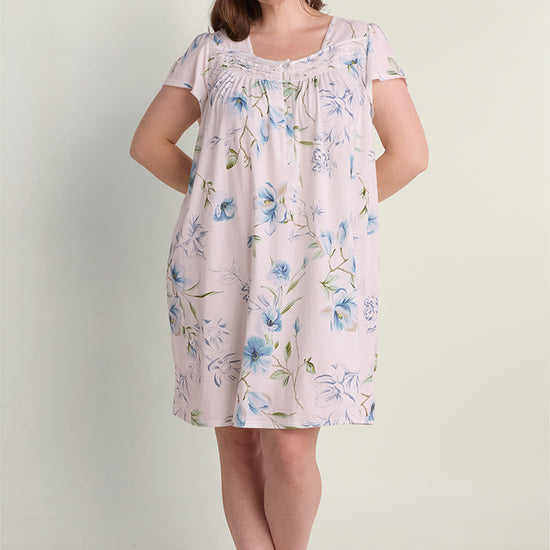Lavender floral short nightgown with blue flowers, short sleeves, and gathered neckline detail on model.