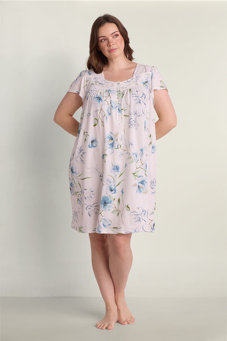 Lavender floral short nightgown with blue flowers, short sleeves, and gathered neckline detail on model.