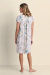 Woman wearing lavender floral short-sleeve nightgown, shown from back view against neutral background.
