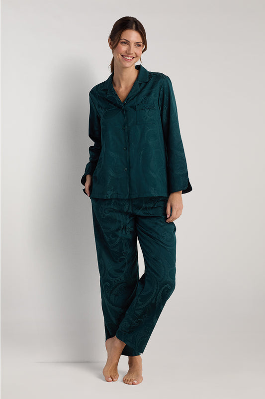 Dark teal brushed back satin pajama set with button-up shirt and matching pants, modeled on woman standing against white