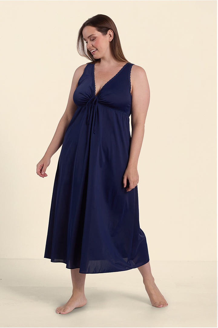Navy blue keyhole fitted nightgown with ruched front detail, modeled on woman standing barefoot against neutral background.
