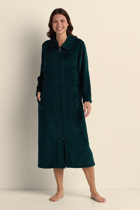 Woman wearing a dark teal fleece long robe with collar and front zip, standing against neutral background.