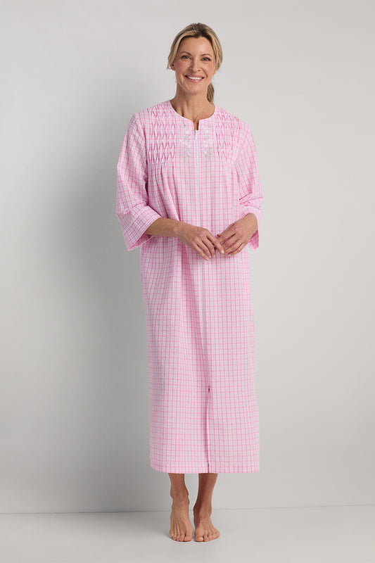 Pink seersucker long zipper robe with check pattern, three-quarter sleeves, modeled on woman against neutral background.
