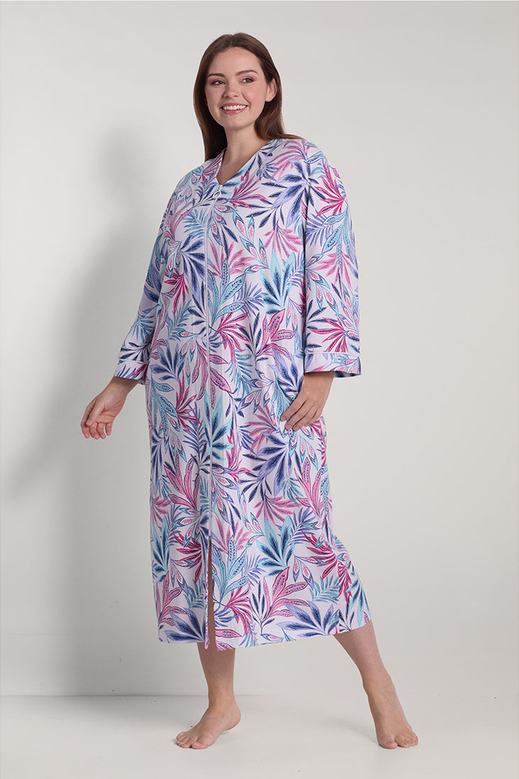 Women's long robe in pink and blue floral interlock knit fabric, displayed on model in full-length front view.